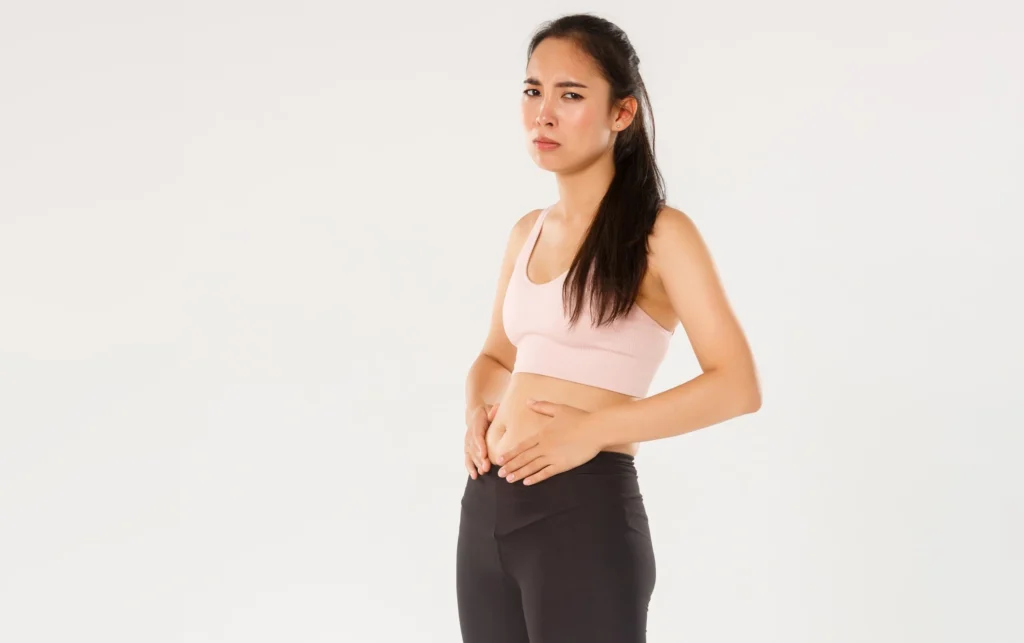 Fiber: The Unsung Hero of Digestive Health and Beyond full length upset gloomy asian fitness girl trying lose weight touching belly cant see res