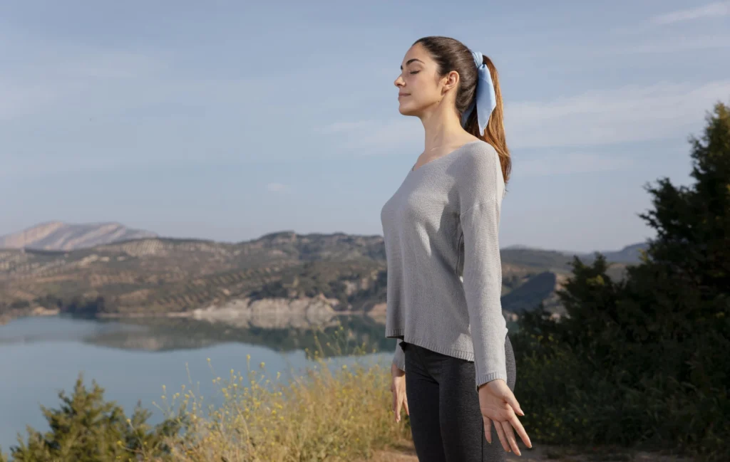side view woman meditating nature